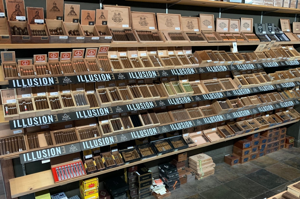 Wall display of Illusione cigars and premium cigar boxes inside FUMARE Fine Cigar Boutique in Reno, Nevada